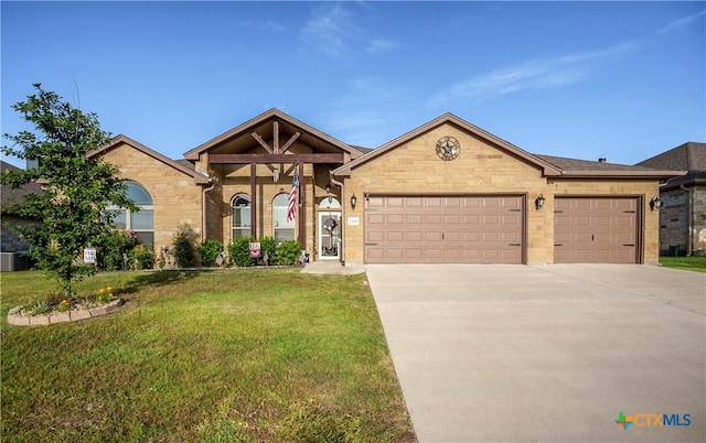 view of front of property featuring a garage and a front lawn