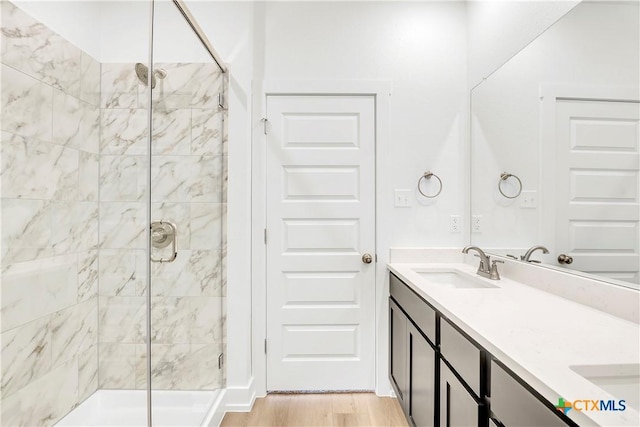 2322 Healy Dr, Temple, TX 76502 - bathroom featuring a stall shower, double vanity, and wood finished floors