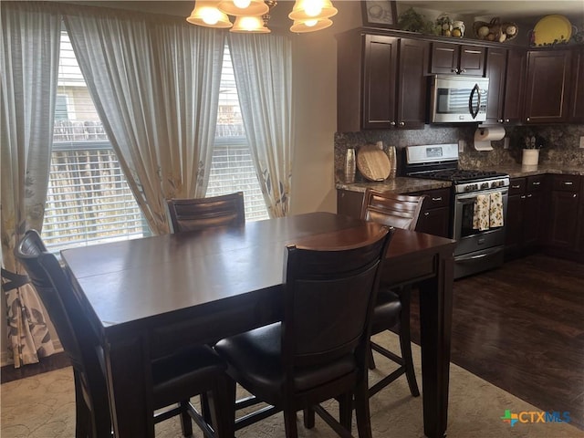 906 2nd St, Cuero, TX 77954 - dining space featuring a chandelier and dark wood-style flooring