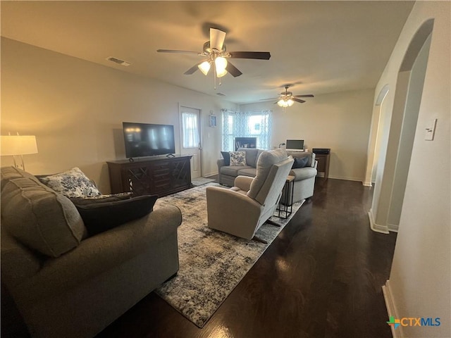 906 2nd St, Cuero, TX 77954 - living area featuring ceiling fan, baseboards, and dark wood finished floors