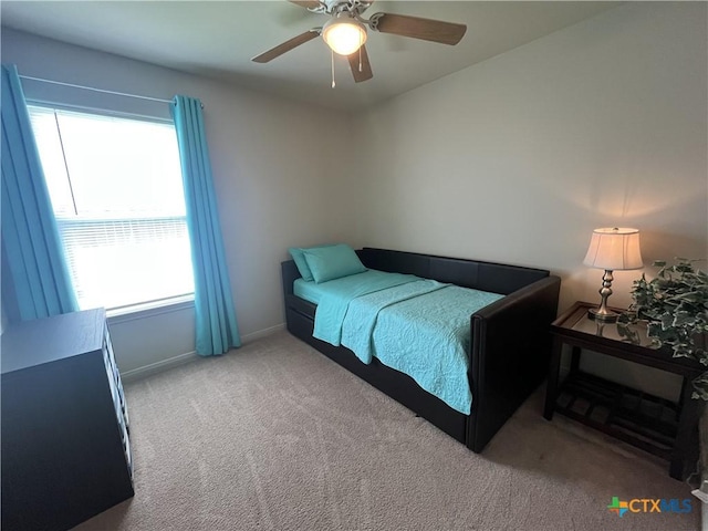 906 2nd St, Cuero, TX 77954 - bedroom with carpet floors, baseboards, and a ceiling fan