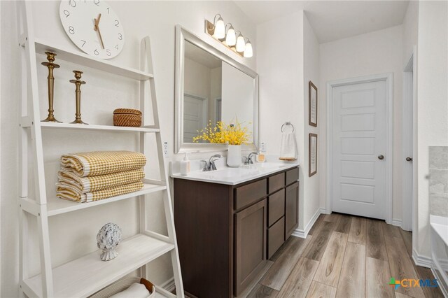 507 Dakota Crk, New Braunfels, TX 78130 - full bath featuring double vanity, wood finished floors, and a bathtub