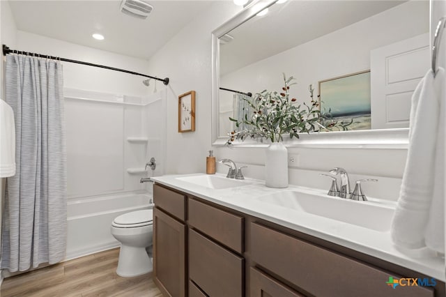 507 Dakota Crk, New Braunfels, TX 78130 - full bath featuring shower / bath combination with curtain, wood finished floors, double vanity, and toilet
