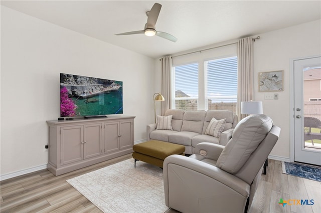 507 Dakota Crk, New Braunfels, TX 78130 - living room with light wood-type flooring, a ceiling fan, and baseboards