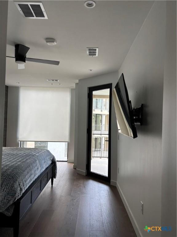 bedroom with access to exterior, dark hardwood / wood-style floors, and ceiling fan