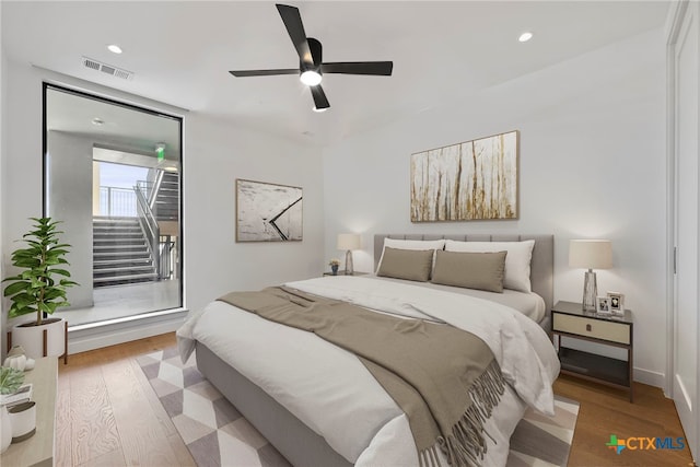 bedroom with ceiling fan and light wood-type flooring