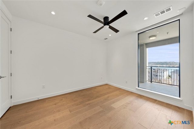 unfurnished room featuring ceiling fan and light hardwood / wood-style floors