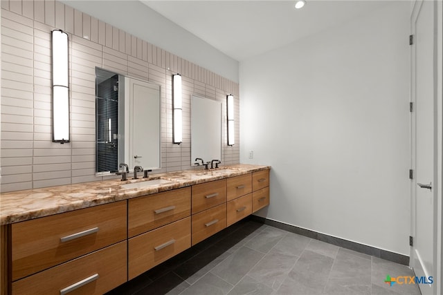 bathroom featuring tasteful backsplash, vanity, and tile patterned flooring