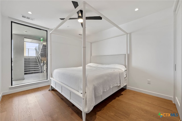 bedroom with hardwood / wood-style floors and ceiling fan