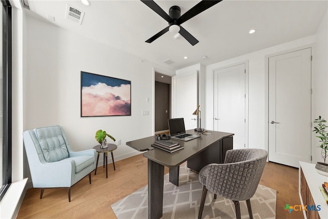 office area with light hardwood / wood-style flooring and ceiling fan