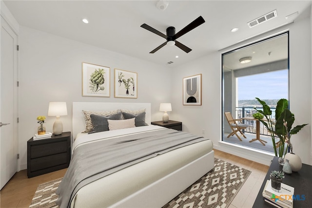 bedroom with ceiling fan and light hardwood / wood-style floors