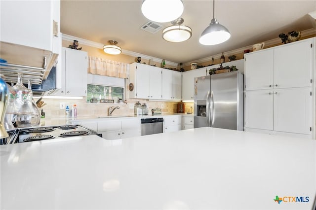 3735 Smoke Signal Rd, Belton, TX 76513 - kitchen featuring appliances with stainless steel finishes, light countertops, decorative backsplash, white cabinetry, and a peninsula