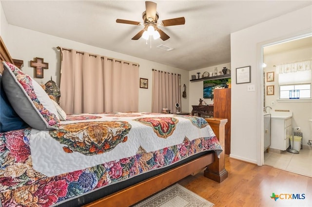 3735 Smoke Signal Rd, Belton, TX 76513 - bedroom with wood finished floors, connected bathroom, and ceiling fan