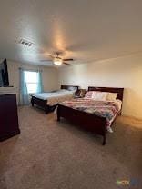 carpeted bedroom with visible vents and ceiling fan