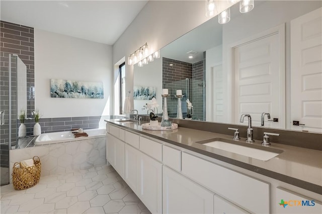 bathroom featuring tile patterned floors, vanity, and plus walk in shower