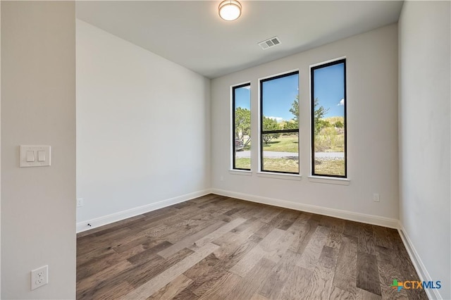 spare room with wood-type flooring