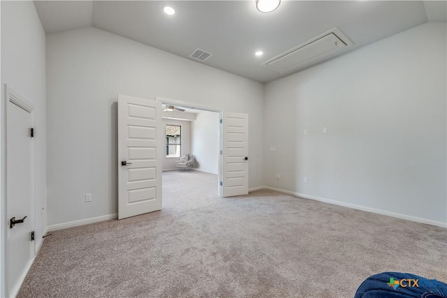 carpeted empty room with lofted ceiling