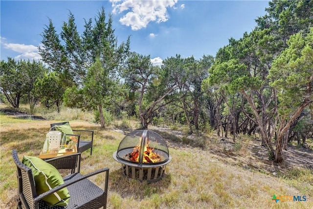 view of yard featuring an outdoor fire pit