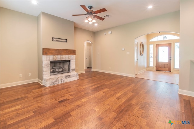 unfurnished living room with hardwood / wood-style floors, a fireplace, and ceiling fan