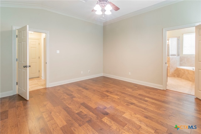 unfurnished bedroom featuring ceiling fan, connected bathroom, crown molding, and wood-type flooring