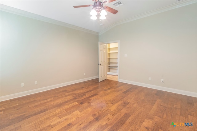 unfurnished room with ceiling fan, vaulted ceiling, hardwood / wood-style flooring, and ornamental molding