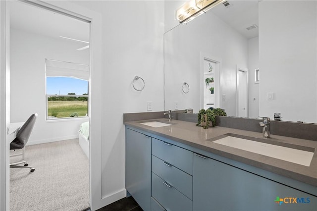 215 Mesa Vista Dr, Leander, TX 78641 - bathroom featuring double vanity and baseboards