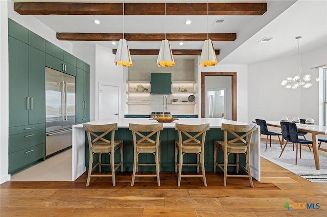 215 Mesa Vista Dr, Leander, TX 78641 - kitchen featuring built in refrigerator, green cabinets, beamed ceiling, light wood finished floors, and light countertops