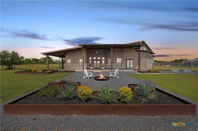 215 Mesa Vista Dr, Leander, TX 78641 - rear view of property with an outdoor fire pit, stone siding, a patio, french doors, and a garden