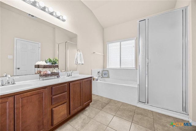 5507 Sulfur Spring Dr, Killeen, TX 76542 - bathroom with lofted ceiling, a shower stall, double vanity, a garden tub, and tile patterned flooring