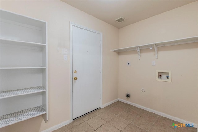 washroom featuring light tile patterned flooring, washer hookup, and hookup for an electric dryer