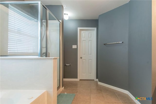 bathroom with tile patterned flooring and a shower with shower door