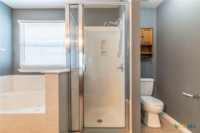 bathroom with toilet, plus walk in shower, and tile patterned flooring