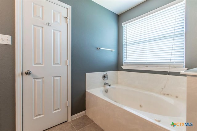 bathroom featuring tile patterned flooring and a bathing tub