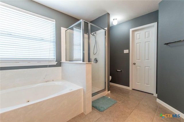 bathroom with independent shower and bath and tile patterned floors