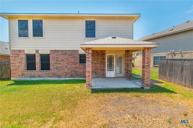 back of property featuring a yard and a patio area