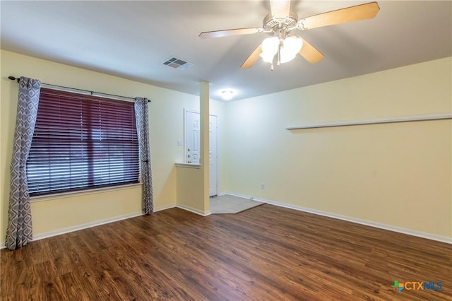 spare room with ceiling fan and dark hardwood / wood-style flooring