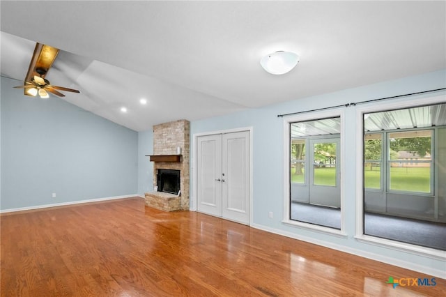 305 Berwick St, Victoria, TX 77904 - unfurnished living room with wood finished floors, a large fireplace, ceiling fan, and vaulted ceiling