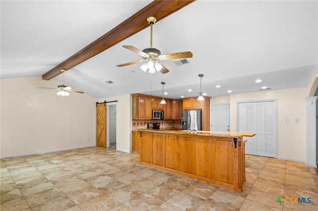 305 Berwick St, Victoria, TX 77904 - kitchen featuring appliances with stainless steel finishes, a ceiling fan, a barn door, decorative backsplash, and recessed lighting
