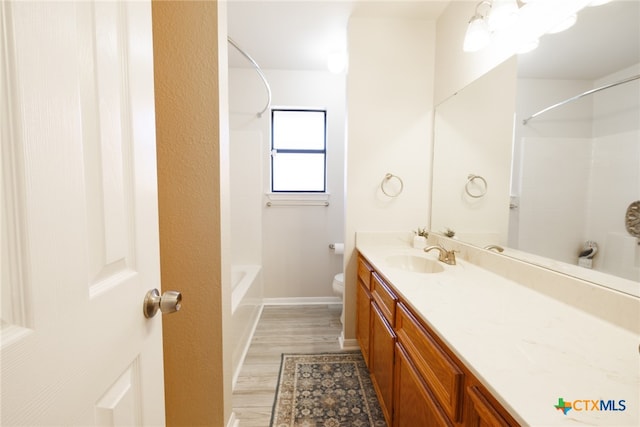 full bathroom with vanity, wood-type flooring, toilet, and shower / bath combination