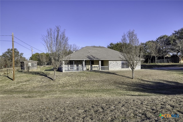 single story home with a front yard and covered porch