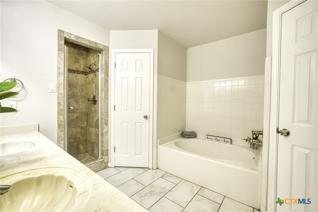 bathroom featuring vanity and shower with separate bathtub