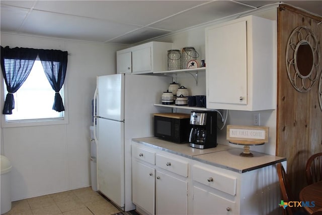 kitchen with white cabinets and white fridge