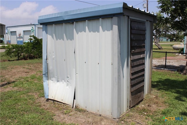 view of outbuilding featuring a lawn