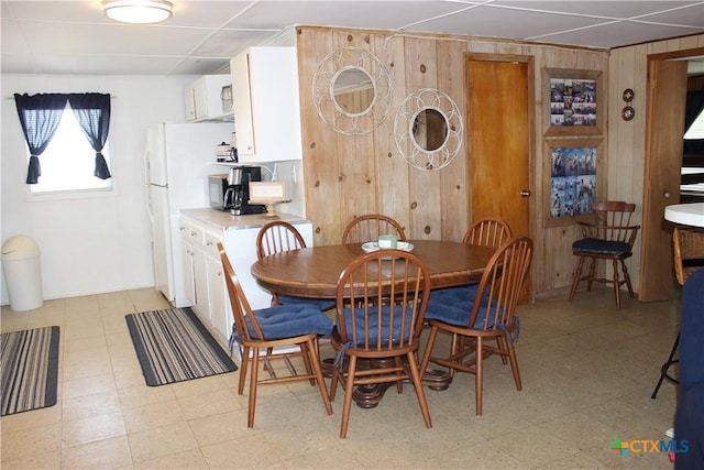 dining space with wooden walls