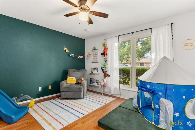 812 Merritt Dr, Lockhart, TX 78644 - sitting room with healthy amount of natural light, wood finished floors, and ceiling fan