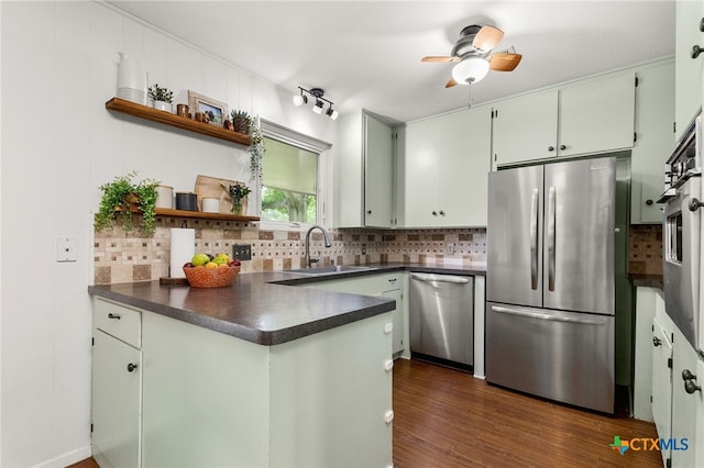 812 Merritt Dr, Lockhart, TX 78644 - kitchen featuring appliances with stainless steel finishes, dark countertops, open shelves, and decorative backsplash