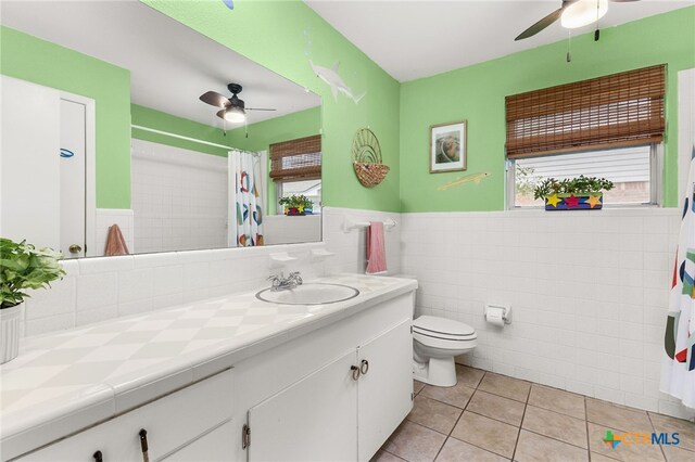 812 Merritt Dr, Lockhart, TX 78644 - full bathroom with a ceiling fan, vanity, tile patterned flooring, plenty of natural light, and tile walls