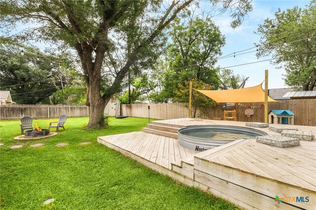 812 Merritt Dr, Lockhart, TX 78644 - view of pool featuring a wooden deck, a fenced backyard, a shed, an outdoor fire pit, and a jacuzzi