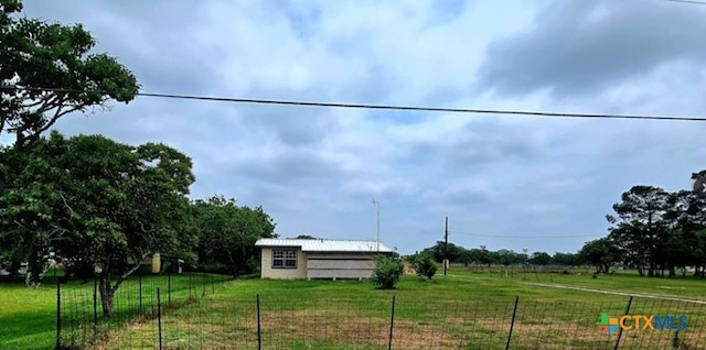 view of yard with a rural view