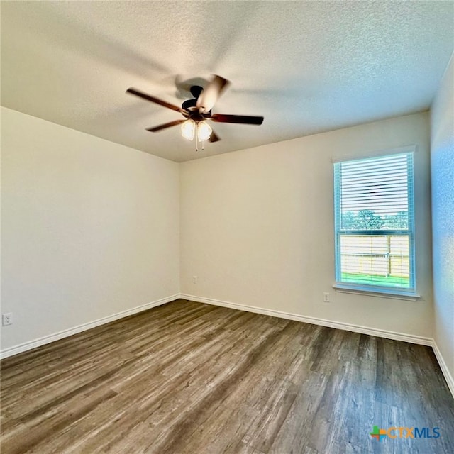 unfurnished room featuring dark hardwood / wood-style flooring, a textured ceiling, and ceiling fan